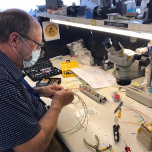 Gary Gorecki assembling test cable harnesses in building 110