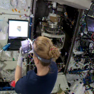 Kate Rubins installing ACE-T sample module on ISS