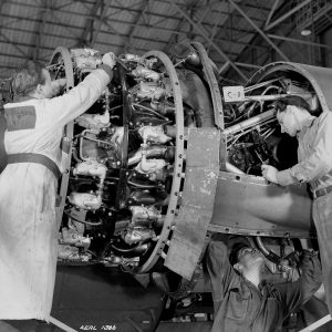 Three Mechanics work on a piston engine in the hangar