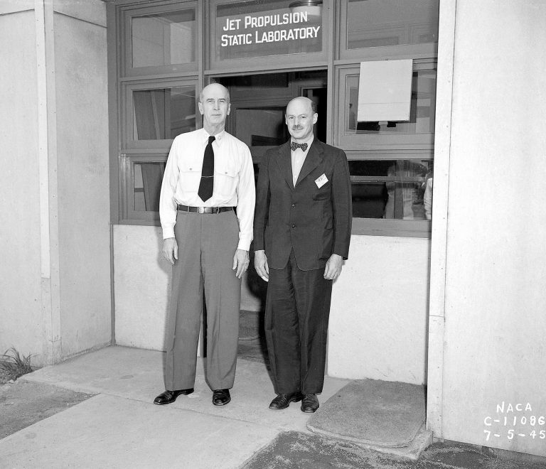 Two men in front of doorway.