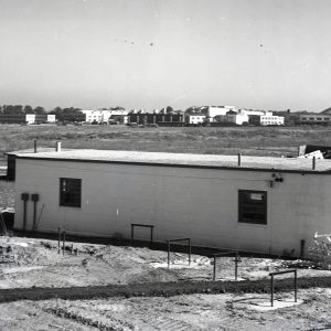 Service Building with hangar in background.
