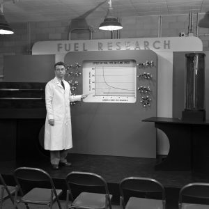 An NACA researcher demonstrates the effect of fuel type on flame speed during the NACA's 1947 Inspection