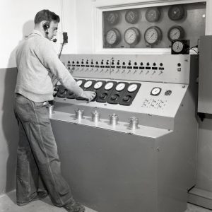 Man at control panel.