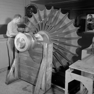 An engineer inspects an impeller from one of the large exhausters in the PSL Equipment Building.
