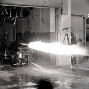 Rocket firing horizontally in test cell.