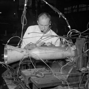 A mechanic installs a small uncooled rocket in the PSL No. 1 test section.