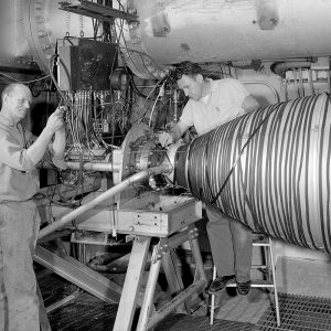 Mechanics install a 20,000-pound thrust rocket engine in PSL No. 1.