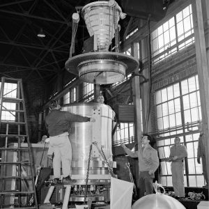 Mechanics in warehouse assemble nuclear engine