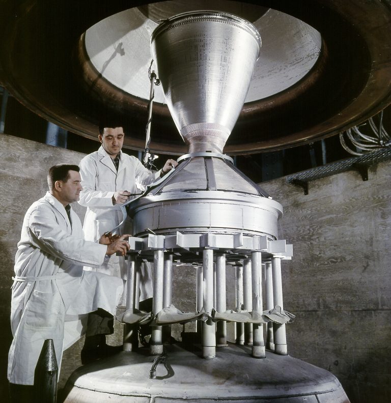 Two technicians work with Kiwi nozzle