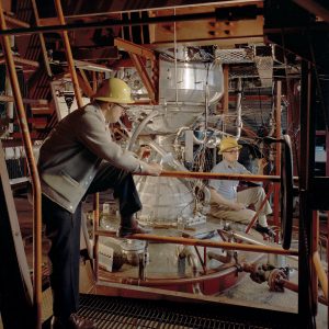 Two engineers examine Kiwi engine in B-1 stand