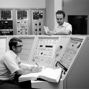 Men in control room.