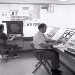 Men at control panels.