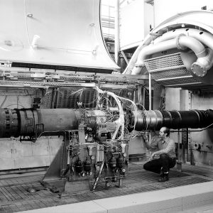 Mechanic with J-85 engine in PSL a test chamber.