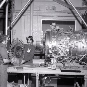 Mechanics with TF-30 engine in shop