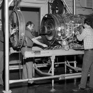 Mechanics prepare a Pratt & Whitney TF-30 turbofan engine for testing in PSL No. 1.