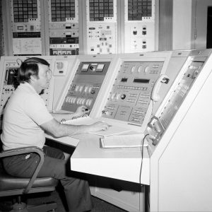 Men at control panels.