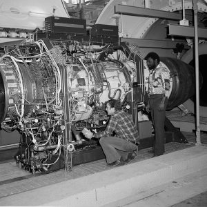 Technicians in PSL No. 1 connect wiring on a Pratt & Whitney F-100 engine.