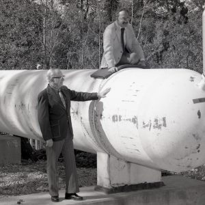 Two men with cylindrical tank