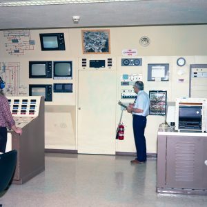 RETF control room showing system schematic, television monitors, and control panels (1987).
