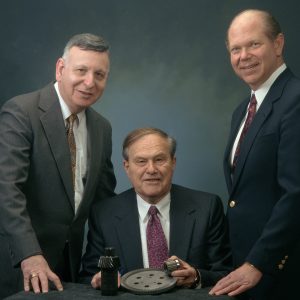 Three men with gears.