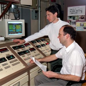 Two men in control room.