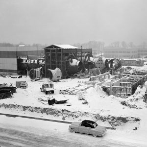 Construction of PSL No. 1 and 2 in January 1951. The two primary coolers for the altitude exhaust are in place within the framework near the center of the photograph. The Shop and Access Building is being built to the left.