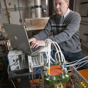 Man with laptop and test equipment.