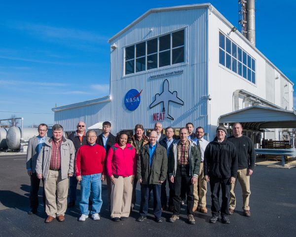 Image of the NEAT team standing outside the facility