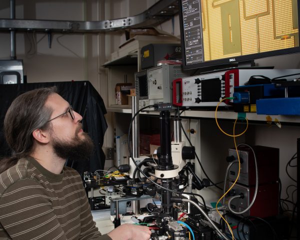 NASA scientist looks up at a computer screen