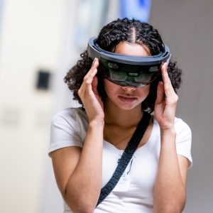 A girl wears an augmented reality headset.