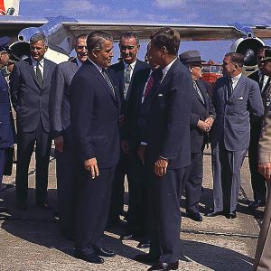 Men standing beside aircraft.