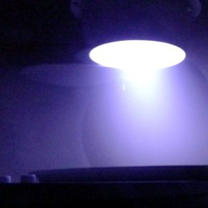Fabrication of sensors, in a dark purple light.