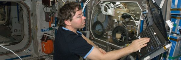 Michael Barratt, a former Explorer, preparing to study microgravity flames on the International Space Station.