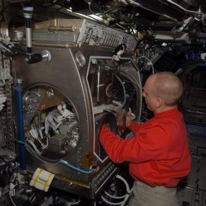 NASA astronaut Clay Anderson, Expedition 15 flight engineer, is seen here working on the Smoke and Aerosol Measurement Experiment (SAME) hardware located in the Microgravity Science Glovebox (MSG) in the Destiny laboratory of the International Space Station. SAME will measure the smoke properties, or particle size distribution, of typical particles that are produced from different materials that can be found onboard station and other spacecrafts.
