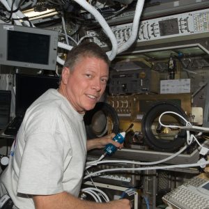NASA astronaut Mike Fossum, Expedition 28 flight engineer, works with Shear History Extensional Rheology Experiment (SHERE) hardware inside the Microgravity Science Glovebox (MSG) located in the Destiny laboratory of the International Space Station