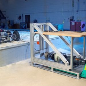 A custom drawbar pull rig applies resistive force to a test vehicle for evaluating traction in soft soil