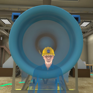 A holographic tour guide avatar stands in front of a large inlet bellmouth in this screenshot.