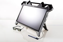 In this picture there are 3 items. Those items are a monitor, 3D glasses and a stylus that is hooked to the monitor. 