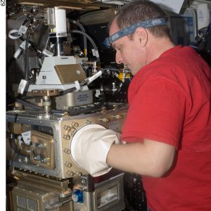 NASA Image: ISS023E056029 - NASA astronaut T.J. Creamer works to setup Light Microscopy Module (LMM) Constrained Vapor Bubble (CVB) hardware in the Fluids Integrated Rack (FIR).