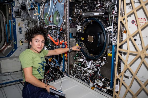 NASA astronaut Jessica Meir performs works to swap out a failed computer hard drive that supports experiments inside the Combustion Integrate Rack.